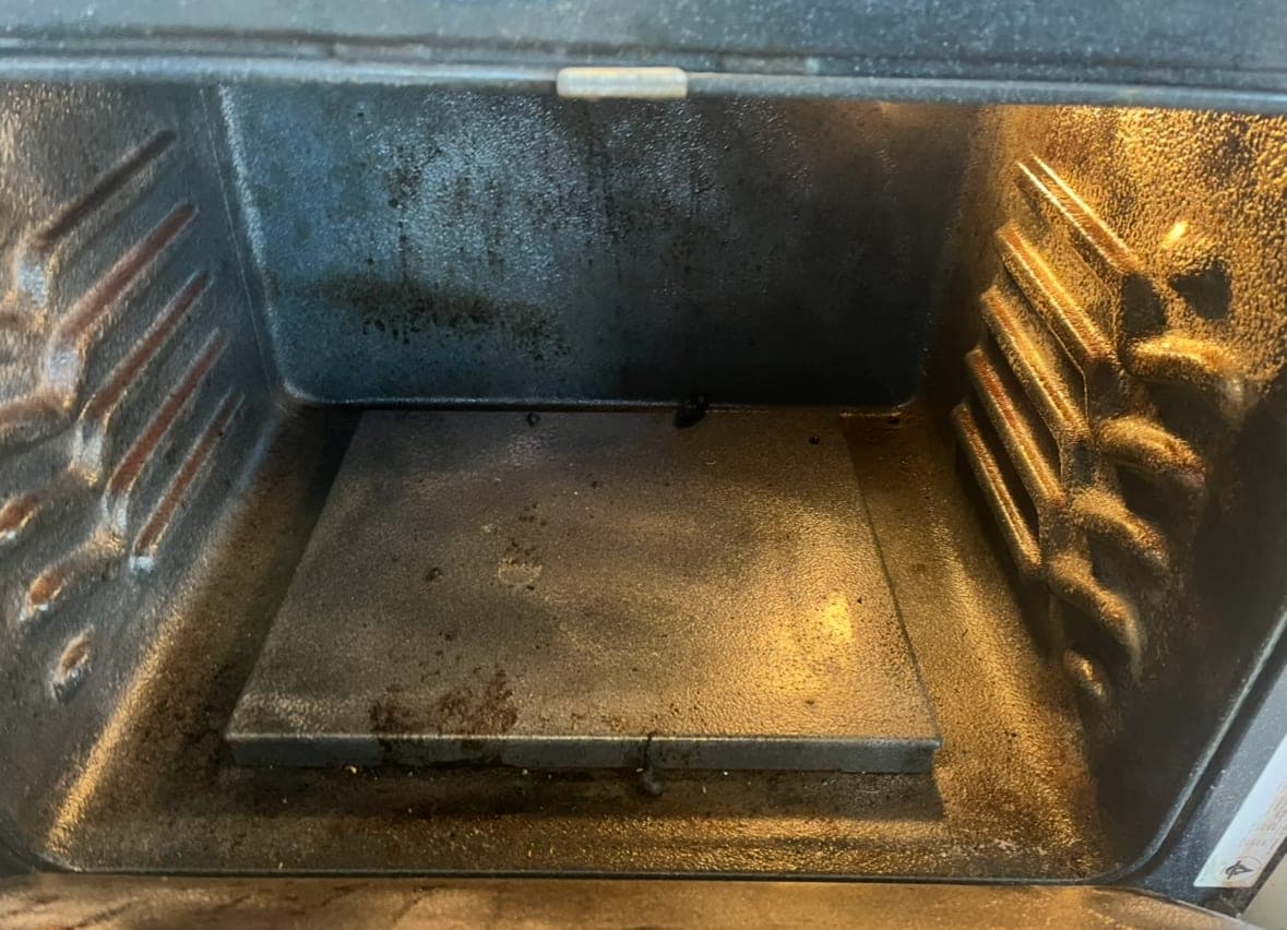Oven interior before cleaning, with baked-on grime