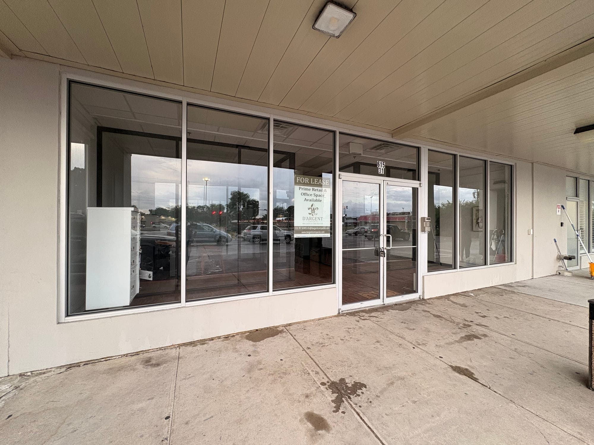 Cleaned floor-to-ceiling glass storefront of a vacant commercial retail space